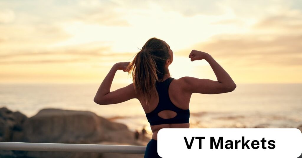 VT Markets How to Build a Profitable Trading Routine Habits of Successful Traders VT Markets Woman flexing her arms at sunrise symbolising strength discipline and confidencekey traits for building a profitable trading routine with VT Markets